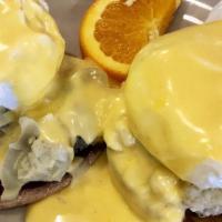 Eggs Temptations · Poached egg, real crab meat and artichoke hearts on an English muffin with hollandaise sauce.