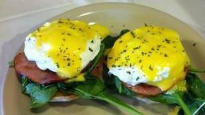 Eggs Benedict Florentine · Poached egg, Canadian bacon and spinach on an English muffin with hollandaise sauce.