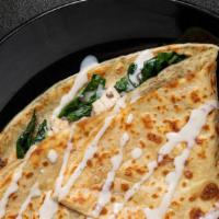Poulet Crêpe · Grilled Chicken Breast, Mushrooms, Spinach, Swiss Cheese, with Housemade Bechamel Sauce.