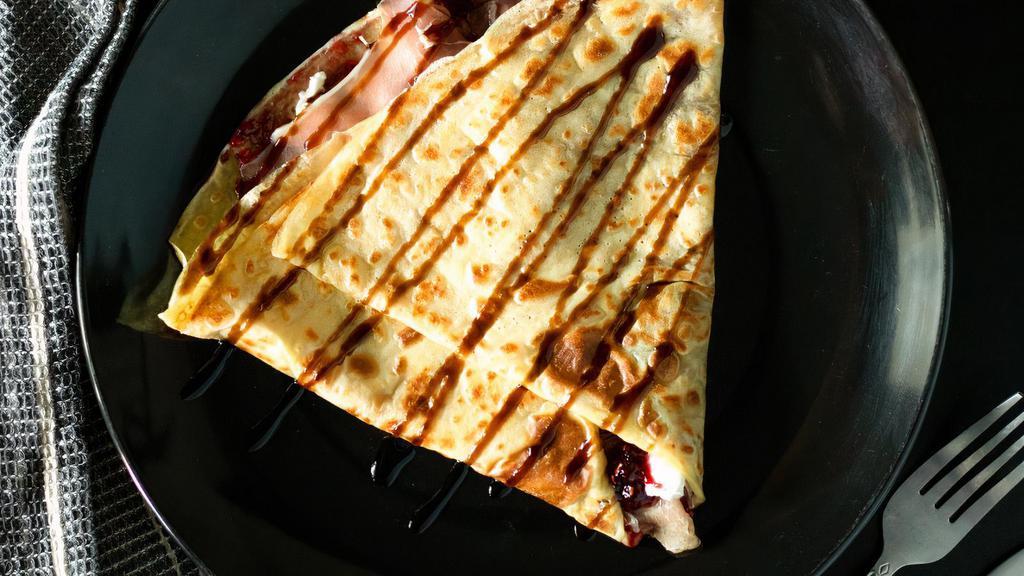 Prosciutto Crêpe · Prosciutto Ham, Goat Cheese, Raspberry Compote, Honey, Balsamic Glaze.