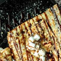 S'Mores Crêpe · Melted Marshmallows, Graham Crackers, Nutella, and Biscoff Spread.