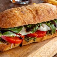 Caprese Sandwich · Slices of fresh mozzarella and tomatoes with basil pesto on a ciabatta roll baked just until...