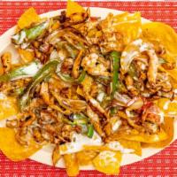 Nacho Fajitas · Chips with chicken and steak bell peppers, onions, and tomatoes and cheese dip.