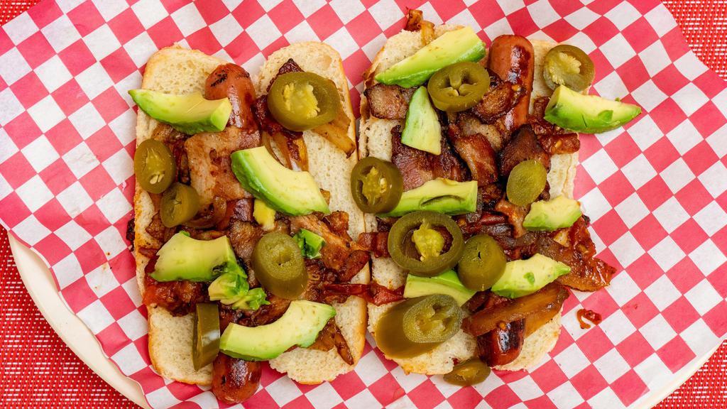 Hot Dog · Delicious hotdog with fresh or grill chopped tomatoes and onions! Along with bacon, freshly diced avocado, and creamy mayonnaise.