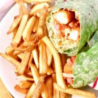Buffalo Chicken Wrap · Spicy fried chicken rolled up in a spinach tortilla with cheese, lettuce, tomato and our spe...