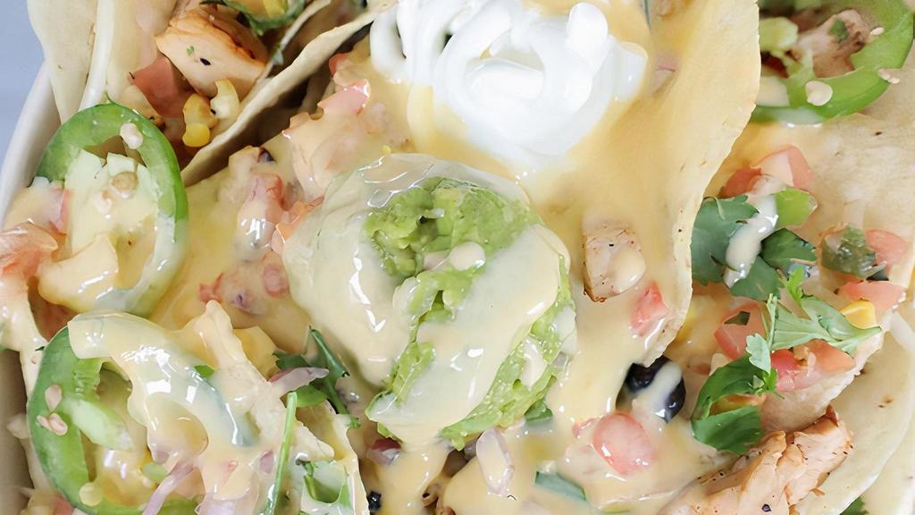 Chicken Nachos · Fresh, all-natural chicken breast, marinated in house dressing, chargrilled