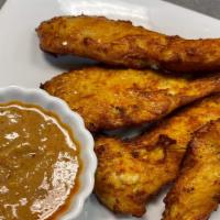 Chicken Satay · Marinated in yellow curry and coconut milk, served with peanut butter sauce