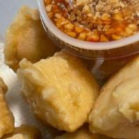 Fried Tofu · Crispy Tofu served with sweet and Sour sauce and crushed Peanuts.