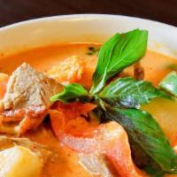  Pineapple Red Curry · Choice of meat and Pineapple in Red curry sauce carrot and tomato and basil leave.