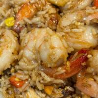 Shrimp Pineapple Fried Rice. · Shrimps fried rice mixed with corn,raisins,carrot,green peas, Tometoes, egg,scallion,and Pin...