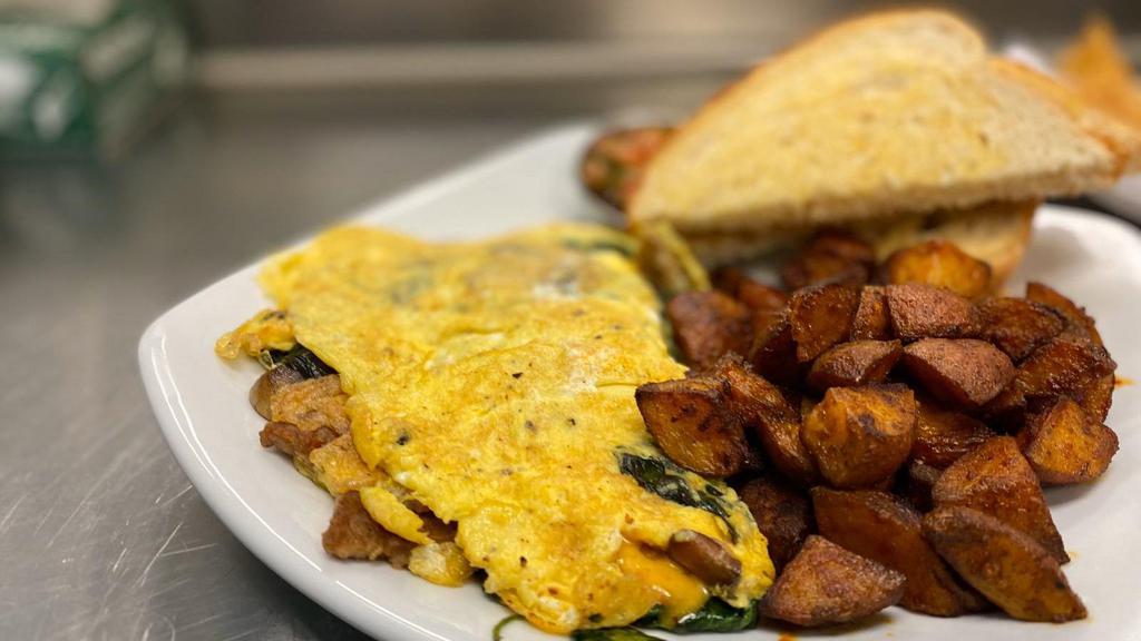Build Your Own Omelet · Three egg omelet with choice of two veggies, one meat, one cheese with toast and one side.