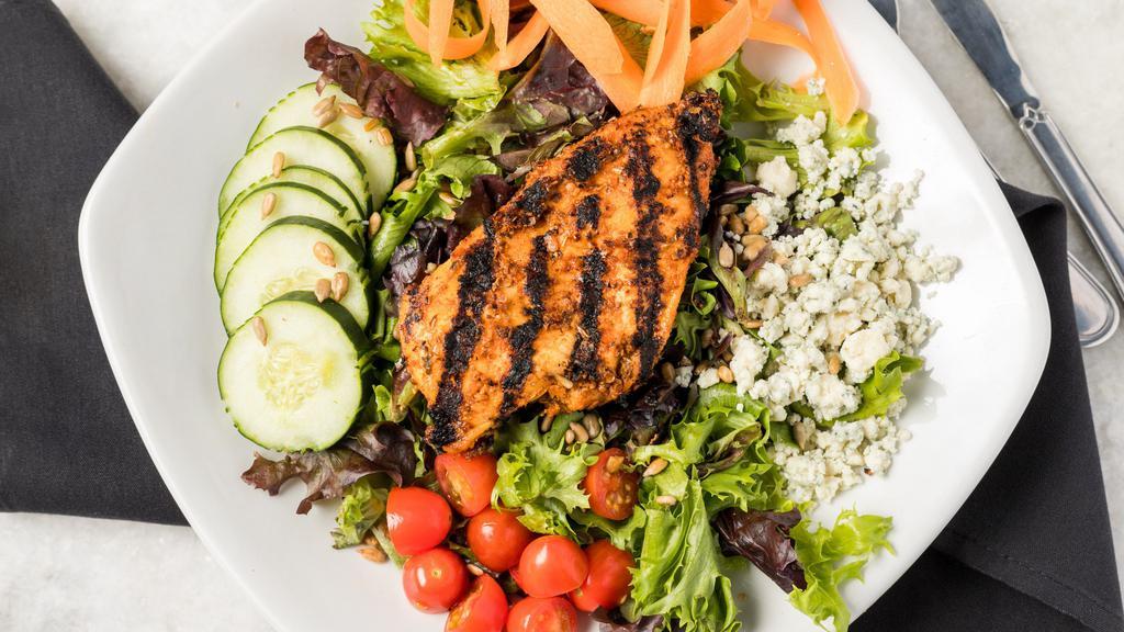 Blackened Blue Salad · Blackened chicken with blue cheese served on a bed of greens with carrots, grape tomatoes, and toasted sunflower seeds.