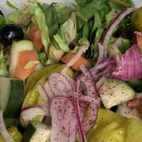 Greek Salad · Romaine lettuce, tomatoes, cucumbers, feta cheese, black olives, onions & pepperoncini.