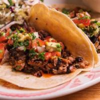 2 Tacos · Your choice of 2 tacos on flour tortillas. Includes one side and garnished with slaw