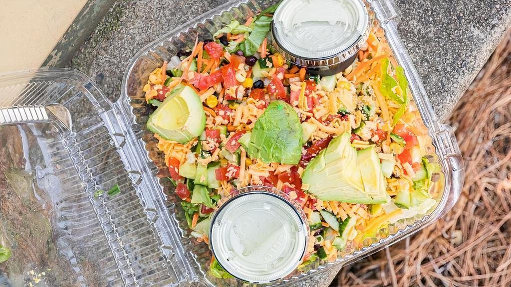 Chopped Salad - Small · Romaine, fire roasted corn, chopped tomatoes, black beans, avocado, carrots, cucumbers and shredded cheddar, tossed with your choice of dressing