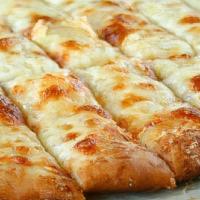 Cheese Bread · Cheesy bread sticks are covered with butter, garlic & herbs, and mozzarella cheese. Served w...