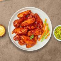 Spicy Buffalo Chicken Wings · Fresh chicken wings fried until golden brown, and tossed in spicy buffalo sauce. Served with...