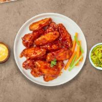 Mild Buffalo Chicken Wings · Fresh chicken wings fried until golden brown, and tossed in mild buffalo sauce. Served with ...