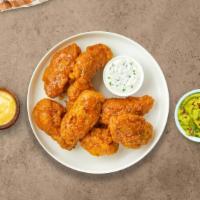 Mango Habanero Wings · Fresh chicken wings fried until golden brown, and tossed in mango habanero sauce. Served wit...