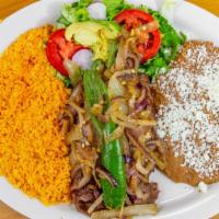 Carne Asada · Grilled, Thinly Sliced Rib-Eye Steak With Rice, Beans, A Small Salad, Grilled Onions And Gri...