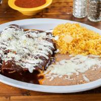 Enchiladas Poblanas · Three tortillas filled with chicken and traditional Mexican mole poblano, cheese and sour cr...