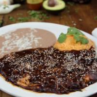 Pollo En Mole · Most popular. Chicken breast with mole sauce served with rice and beans.