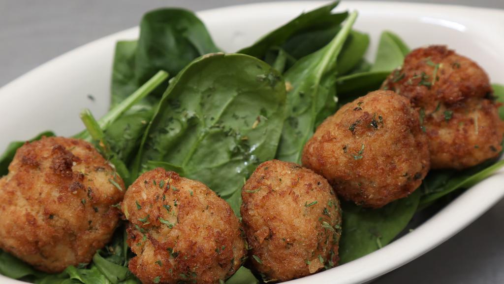 Crab Balls · Our Signature Crab cake mix, served in a meatball form, fried to a crispy golden brown, served with our special dipping sauce
