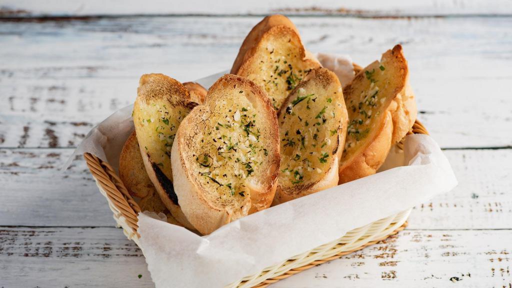 Garlic Bread · Fresh-baked pizza dough brushed with zesty garlic sauce and topped with mozzarella cheese.