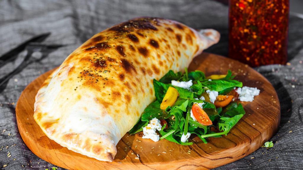 Large Meatball Calzone · Folded pie made with fresh dough, and stuffed with a blend of cheeses, meatballs, herbed ricotta, and mozzarella. Served with a house special marinara sauce.