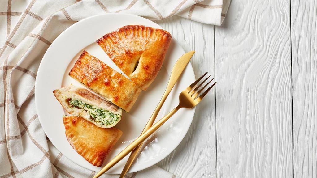 Large Spinach And Artichoke Calzone · Folded pie made with fresh dough, and stuffed with a blend of cheeses, spinach and artichoke hearts mingled with garlic sauce, herbed ricotta, and mozzarella. Served with a house special marinara sauce.
