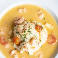 Gulf Shrimp & Grits · Gulf shrimp lightly sautéed in white wine and butter with cherry tomatoes, shallots, fresh h...