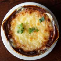French Onion Soup · Classic beef stock with caramelized onions, house-made croutons, topped with swiss and provo...