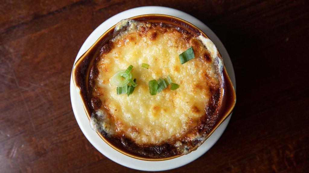French Onion Soup · Classic beef stock with caramelized onions, house-made croutons, topped with swiss and provolone cheeses.