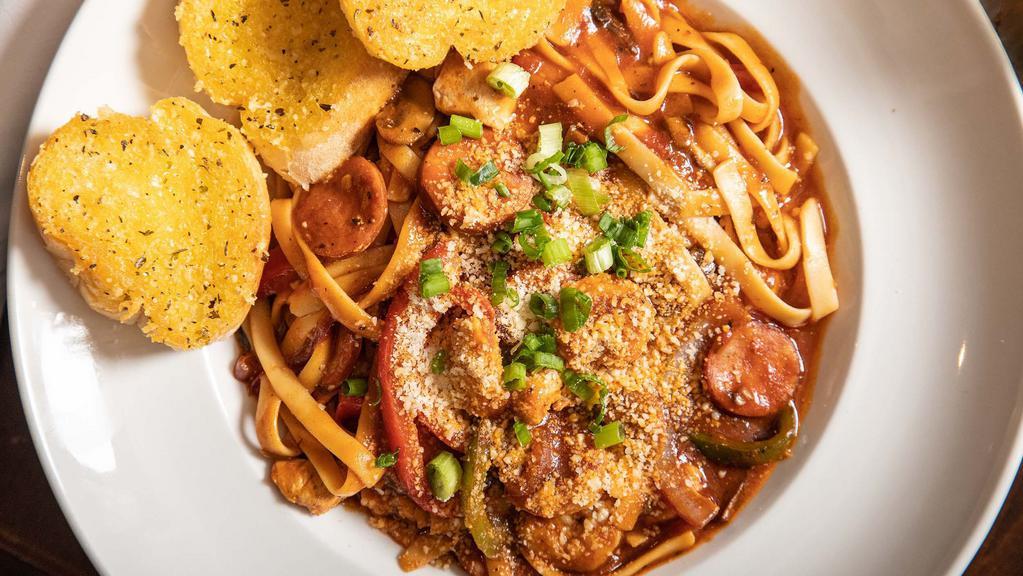 Jambalaya Pasta · Gulf shrimp, chicken, smoked sausage, onions, peppers and mushrooms in a spicy creole sauce tossed with fettuccine pasta.