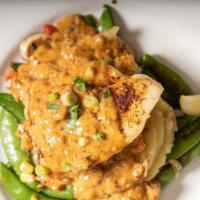 Creole Stuffed Fish · Southern gulf fish fillet stuffed with crawfish dressing, baked and topped with a crawfish c...