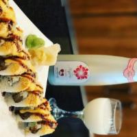 Hero Roll · Shrimp tempura, cucumber, cream cheese, avocado topped with spicy crab, tempura flakes, spic...