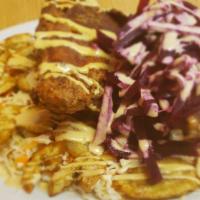 Pollo Con Tajadas · Fried chicken and plantains topped with a special sauce and served over shredded cabbage sal...