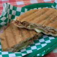 Cubano (Classic Cuban) · Smoked honey ham, slow roasted pork, with swiss cheese, layered with pickles and mustard. Se...