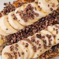 Banana Toast · Regular. Local flax bread toasted golden and topped with creamy peanut butter, organic slice...