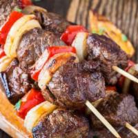 Beef Kebabs · Two skewers of tender ribeye steak tips, seasoned to perfection.