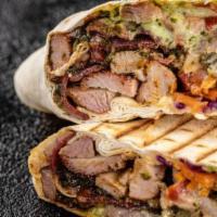 Beef Shawarma · Thinly sliced lean inside round steak, marinated over-night,  cooked on a vertical rotisseri...