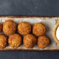 Falafel · Falafel (chickpeas, cilantro, g.onions, and spices) topped with tahini sauce.
