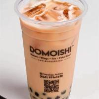 House Milk Tea · Premium house blends black tea with milk and topped with honey boba.