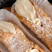 Cannoli · Italian pastry shell filled with sweetened ricotta cheese & chocolate bits.