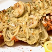 Da Loaded Stuffed Lobster · Large Gulf Lobster stuffed with our famous seafood pasta with cream sauce.