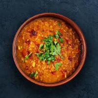Dal Tadka  · Slow-cooked lentils tempered with herbs and whole red chillies.