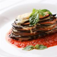 Eggplant Parmesan · Sliced fresh eggplant with spaghetti marinara, mozzarella, and parmesan with freshly baked b...
