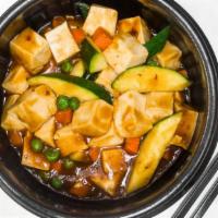 Mapo Tofu · Spicy. Sautéed silky tofu with peas and carrots in fiery bean paste sauce.