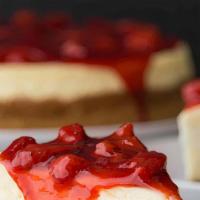 Strawberry Topping Over Cheesecake · New York-style cheesecake on top of a graham cracker crust. Topped with strawberry topping.