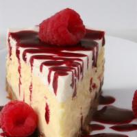 Raspberry Topping Over Cheesecake · New York-style cheesecake on top of a graham cracker crust. Topped with raspberry topping.